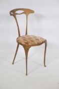 A painted metal side chair, with pierced back, raised on shaped supports, early C20th