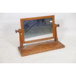 An Arts and Crafts oak swing toilet mirror, 10" x 30" x 20"