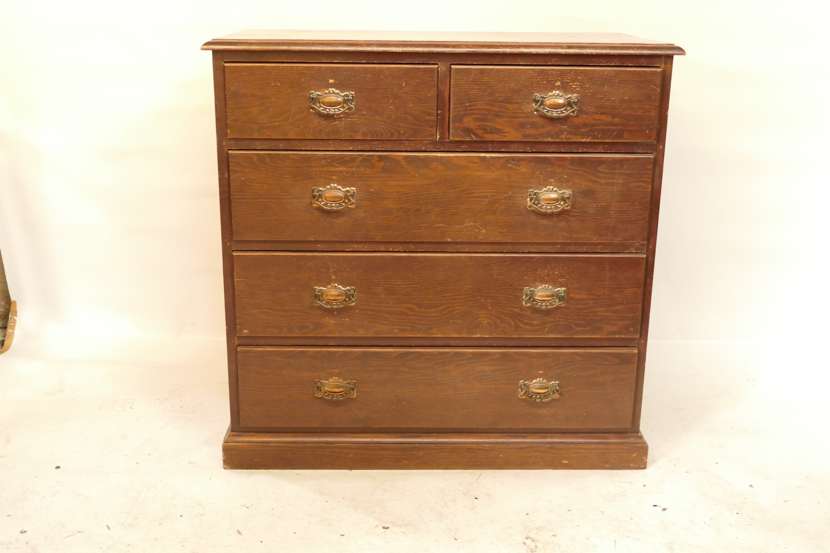 A Victorian pitch pine chest of two over three drawers, on a plinth base