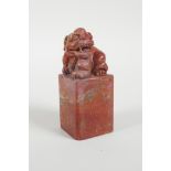 A Chinese red soapstone seal with a carved kylin knop, 3" high