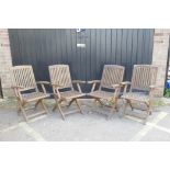 A set of four teak folding garden chairs
