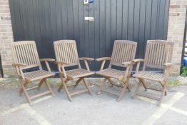 A set of four teak folding garden chairs