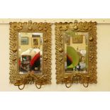A pair of C19th pressed brass framed pier glass wall mirrors with twin candle sconces, the frames