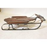 A wrought metal and wood 'Airline Pursuit' child's sled, 24" x 9" x 6"