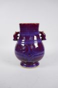 A Chinese purple flambe glazed pottery two handled vase, impressed seal mark, 9½" high