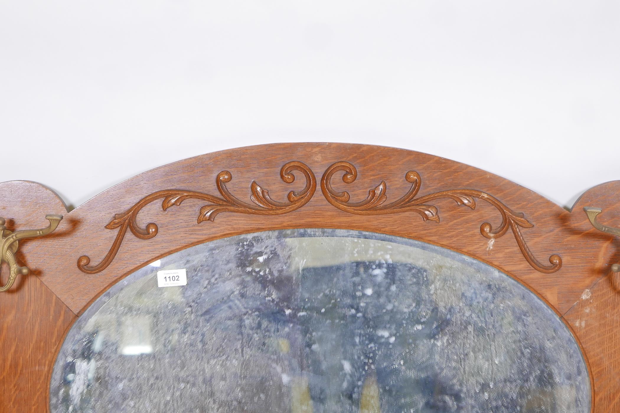 An American oak wall mirror with moulded decoration, fitted with four coat hooks, late C19th/early - Image 2 of 3