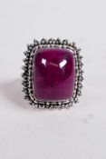 An approximately 20ct cabochon and natural ruby gemstone ring set in sterling silver, stamped 925,