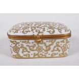 A French porcelain trinket box with gilt scrolling decoration, 4" x 3" x 2"