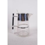 A Christopher Dresser style cut glass jug with silver plated mounts, 9½" high
