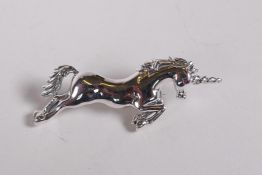 A sterling silver brooch in the form of a unicorn, 2" long