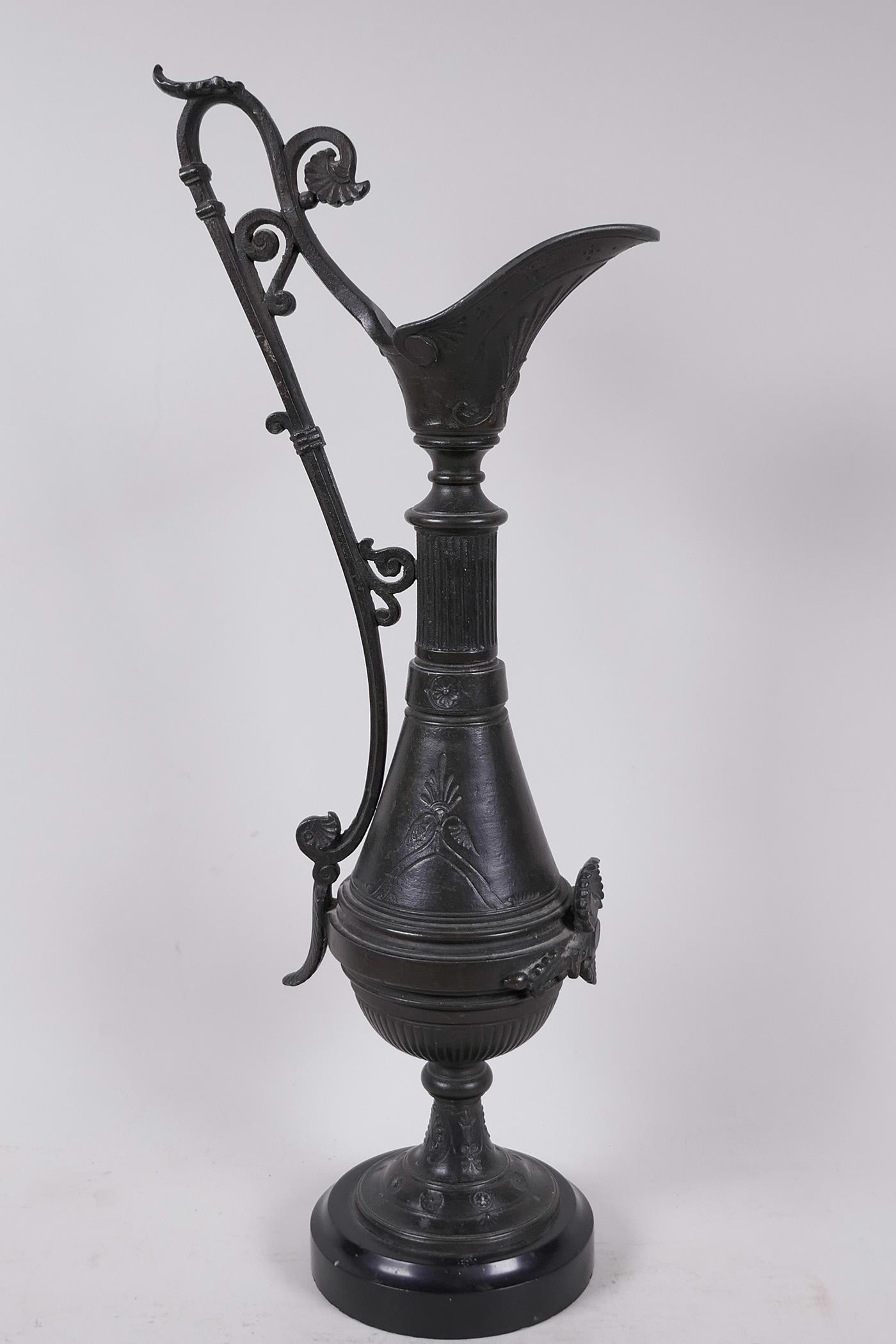 A C19th aesthetic bronze ewer with engraved and applied decoration, mounted on a marble base, 17"