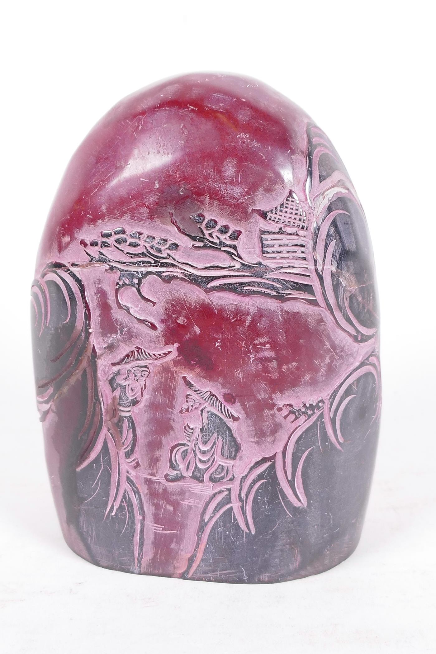A Chinese soapstone seal decorated with figures in a landscape, 5" high, 3¼" wide