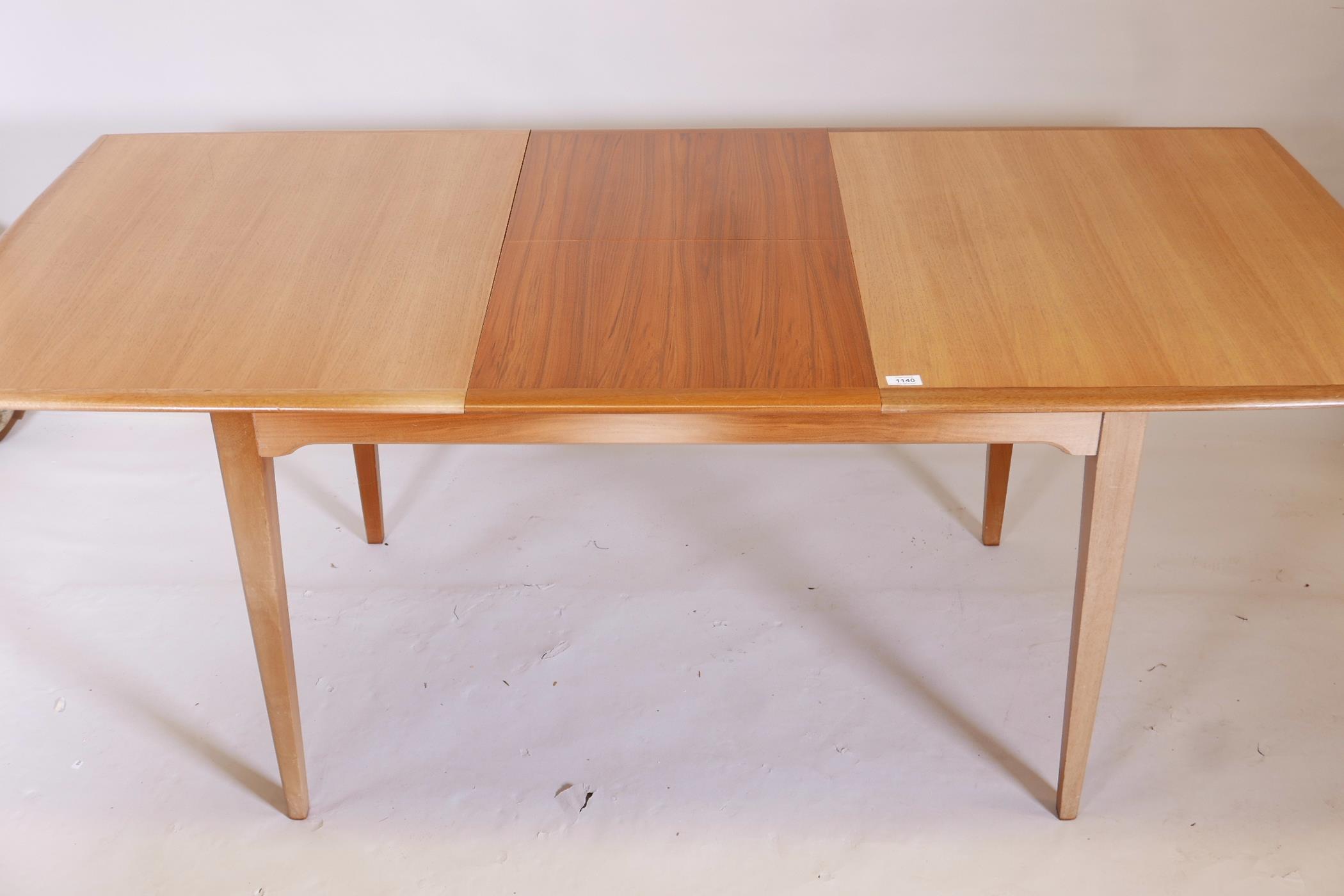 A 1970s teak extending dining table on square tapering supports, with built in leaf, and two - Image 3 of 3