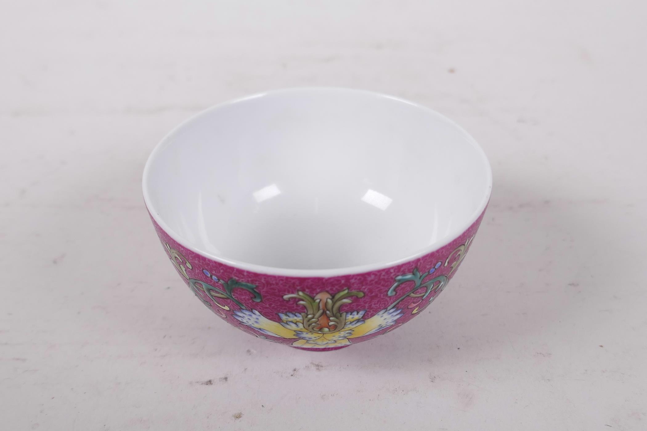 A Chinese polychrome porcelain tea bowl, with enamel lotus flower decoration on a pink ground, - Image 2 of 6