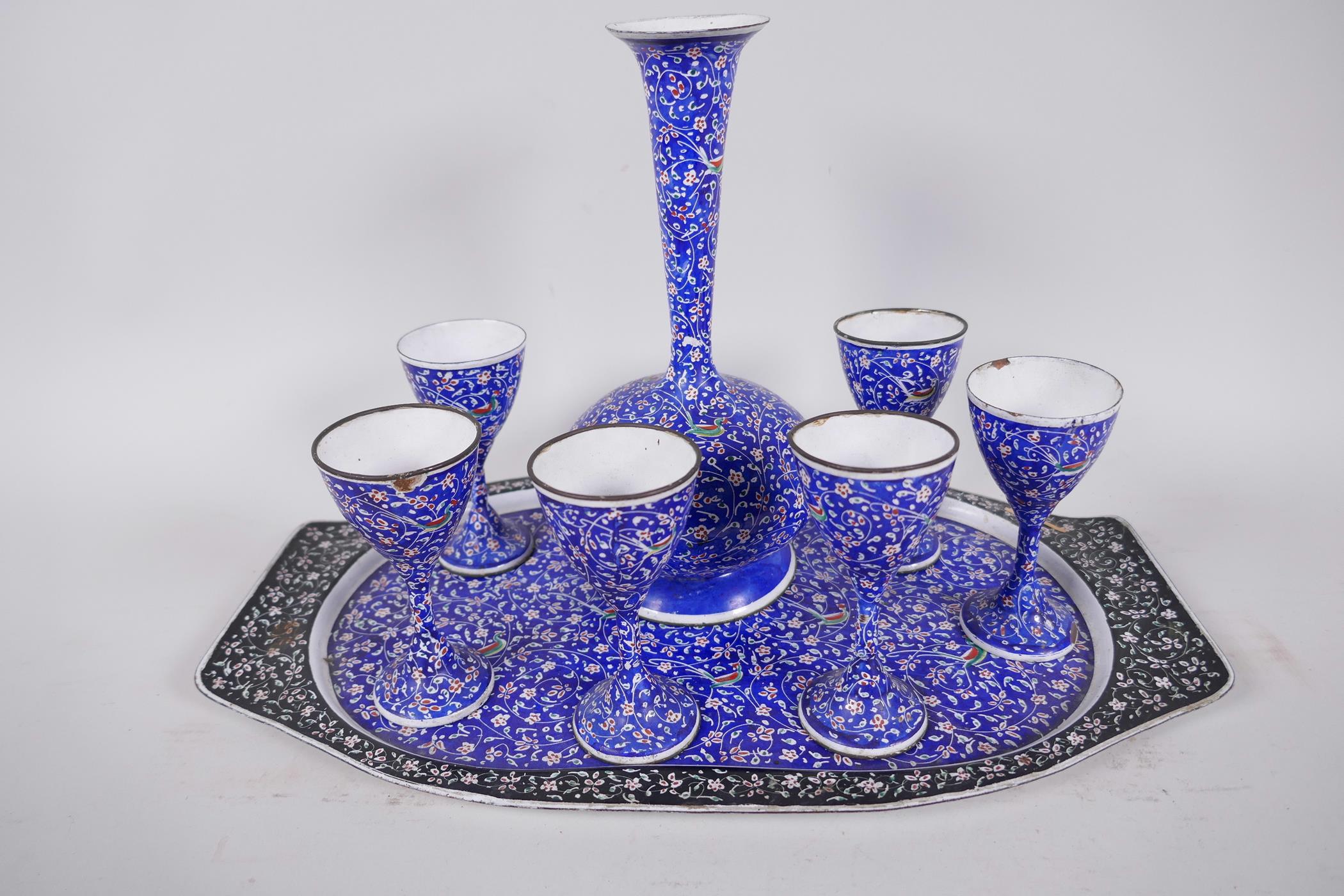 An Indian enamel wine set of carafe and six stem cups on a tray, carafe 7½" high
