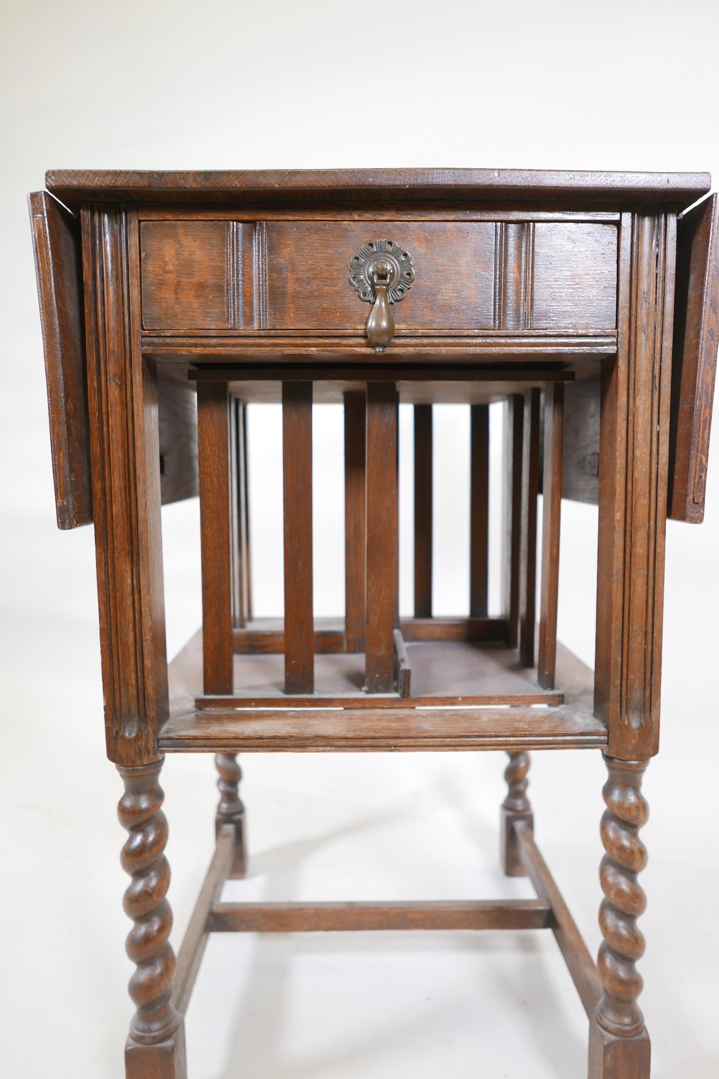 A Waring & Gillow oak dropleaf side table incorporating a revolving bookcase, raised on - Image 3 of 6