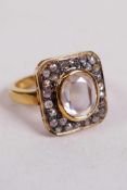 A white moissanite diamond, flat oval cut, set in gilded sterling silver, stamped 925, and