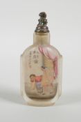 A Chinese reverse decorated glass snuff bottle depicting an erotic scene, inscription verso, 3½"