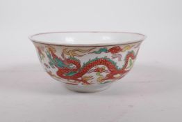 A Chinese polychrome porcelain rice bowl decorated with dragons to exterior and a phoenix to the