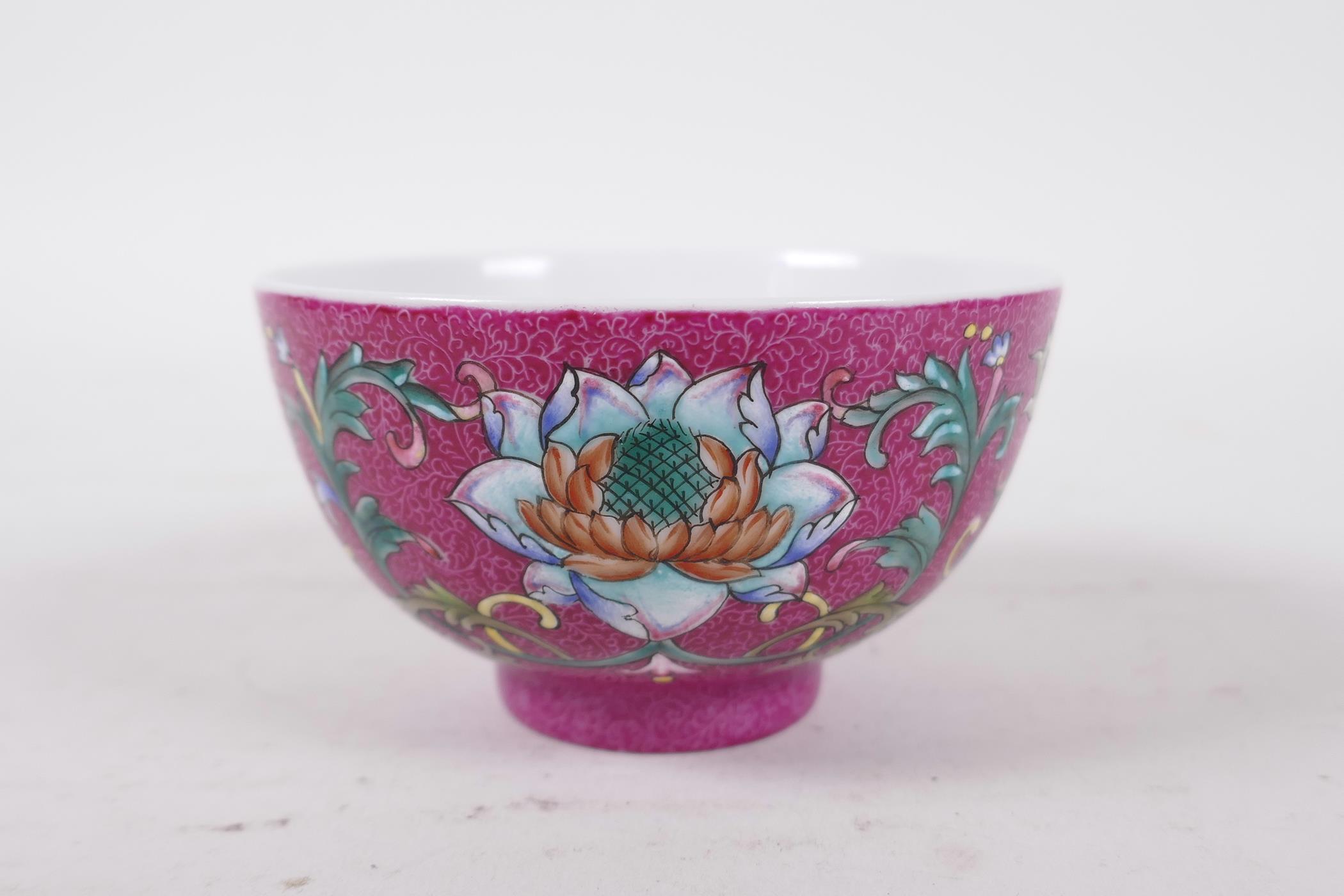 A Chinese polychrome porcelain tea bowl, with enamel lotus flower decoration on a pink ground, - Image 4 of 6