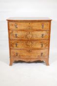 A figured walnut bow front chest of four long drawers with drop handles, raised on splay supports,