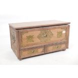 A teak Zanzibar mule chest, with pierced brass mounts and shaped mouldings, two drawers under a lift