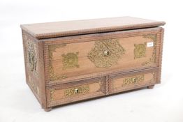 A teak Zanzibar mule chest, with pierced brass mounts and shaped mouldings, two drawers under a lift