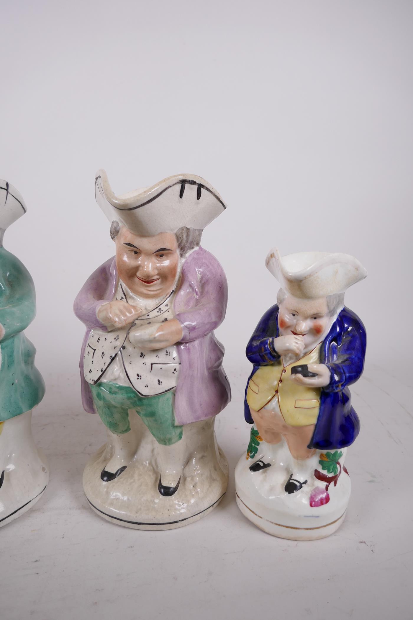 Four antique Staffordshire Toby jugs, a Ralph Wood style 'Toper' and three snuff takers, largest 10" - Image 3 of 3