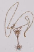 A 9ct gold pendant in the form of a spider's web and spider set with seed pearls and blue
