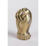 A brass vesta case in the form of a clenched fist, 1½"