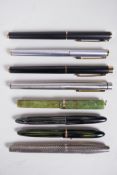 An assorted collection of Sheaffer fountain pens including a sterling silver cased pen, all appear