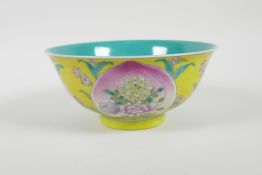 A Chinese polychrome porcelain rice bowl decorated with peaches and flowers on a yellow ground, 6