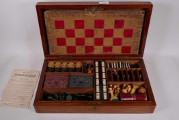 A John Jaques and Son Ltd mahogany cased games compendium, containing draughts, chess, bezique,