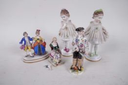A small Dresden porcelain figure of a dandy with a short sword, 3½" high, together with four other