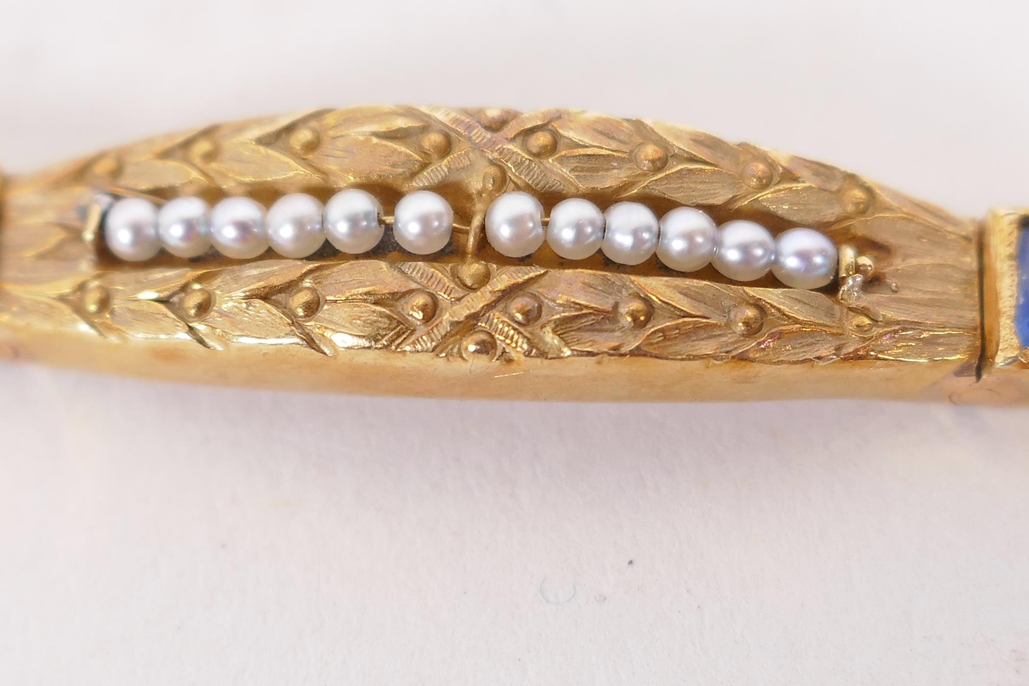 An 18ct gold bangle set with sapphires and seed pearls, and having bark finish engraving (15 grams - Image 6 of 6