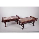 A pair of Chinese carved hardwood stands, with pierced friezes of grape and vine leading down to