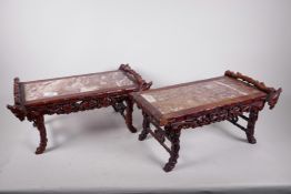 A pair of Chinese carved hardwood stands, with pierced friezes of grape and vine leading down to