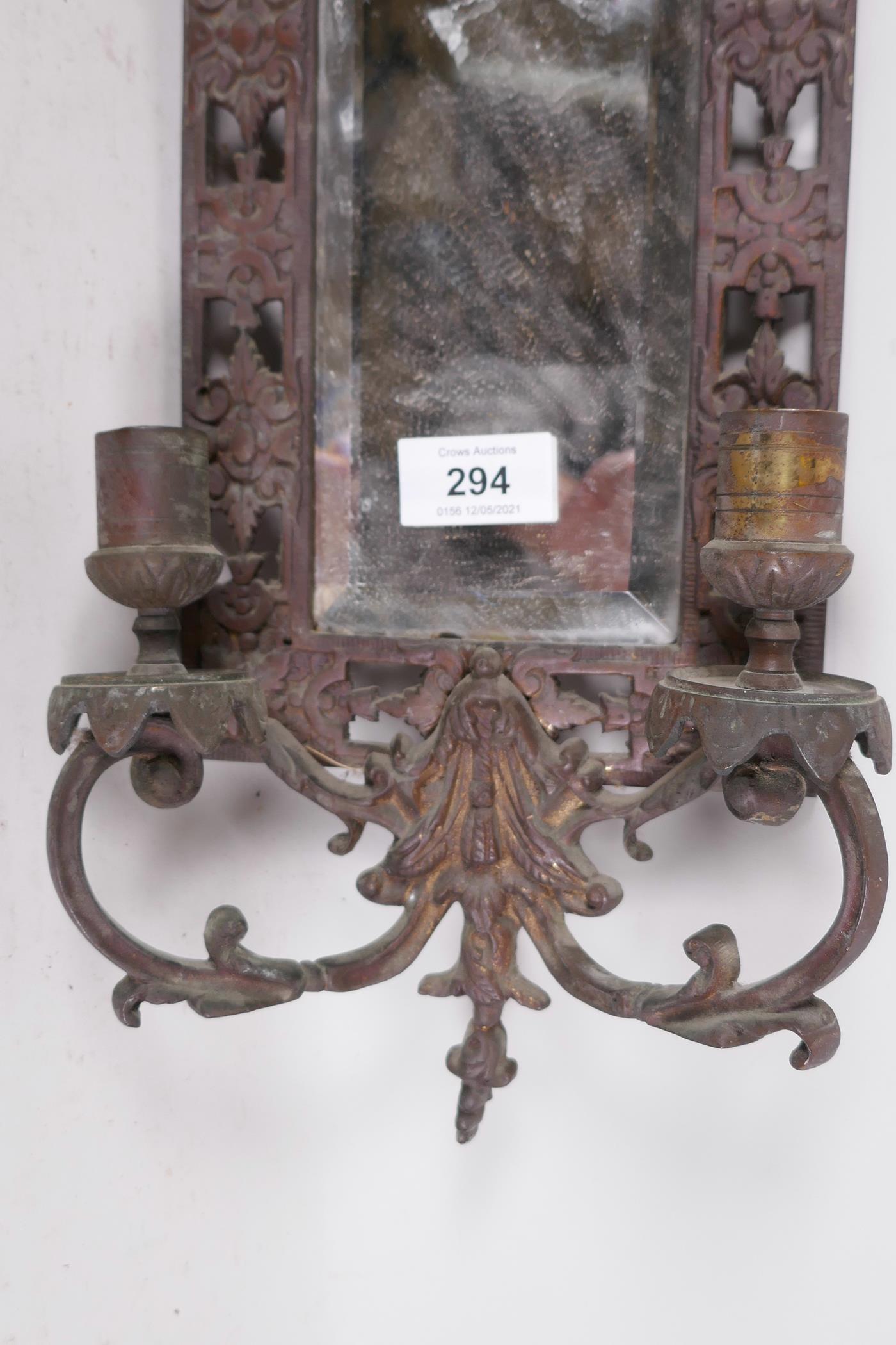 A bronzed metal two branch wall sconce, with inset bevelled glass mirror and dolphin crest, 23" x 7" - Image 3 of 3