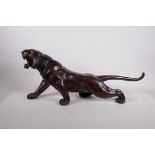 A Meiji bronze tiger, well modelled and patinated, signed to the base, lacks a glass eye, minor