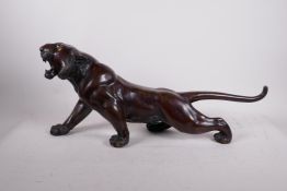 A Meiji bronze tiger, well modelled and patinated, signed to the base, lacks a glass eye, minor