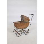 A metal framed and cane doll's pram, early C20th, 22" x 8" x 24"