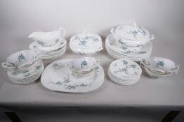A Coalport 'Tintern' dinner service in the shape first produced by Coalport in 1812 comprising one
