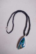 A cabochon blue sapphire gemstone necklace with an azurite pendant mounted in sterling silver,