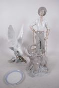 A Lladro figure of a diving seagull, 11" high, together with a Lladro figure of a fisherman with two