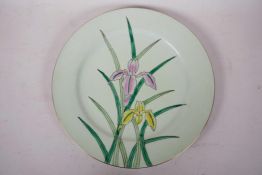 A Chinese Qianlong porcelain plate decorated with irises on a pale green ground, red seal mark to