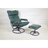 An American mid century leather upholstered tilt and swivel easy chair with matching footstool