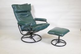 An American mid century leather upholstered tilt and swivel easy chair with matching footstool