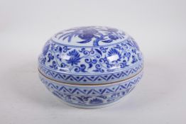 A Chinese blue and white porcelain cylinder box and cover decorated with birds in a fruit tree, 6