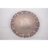 A hallmarked silver card tray with shaped rim on three scrolled feet, hallmarked London 1967 with