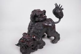 A Chinese bronze censer modelled as two fighting fo dogs, 12" wide